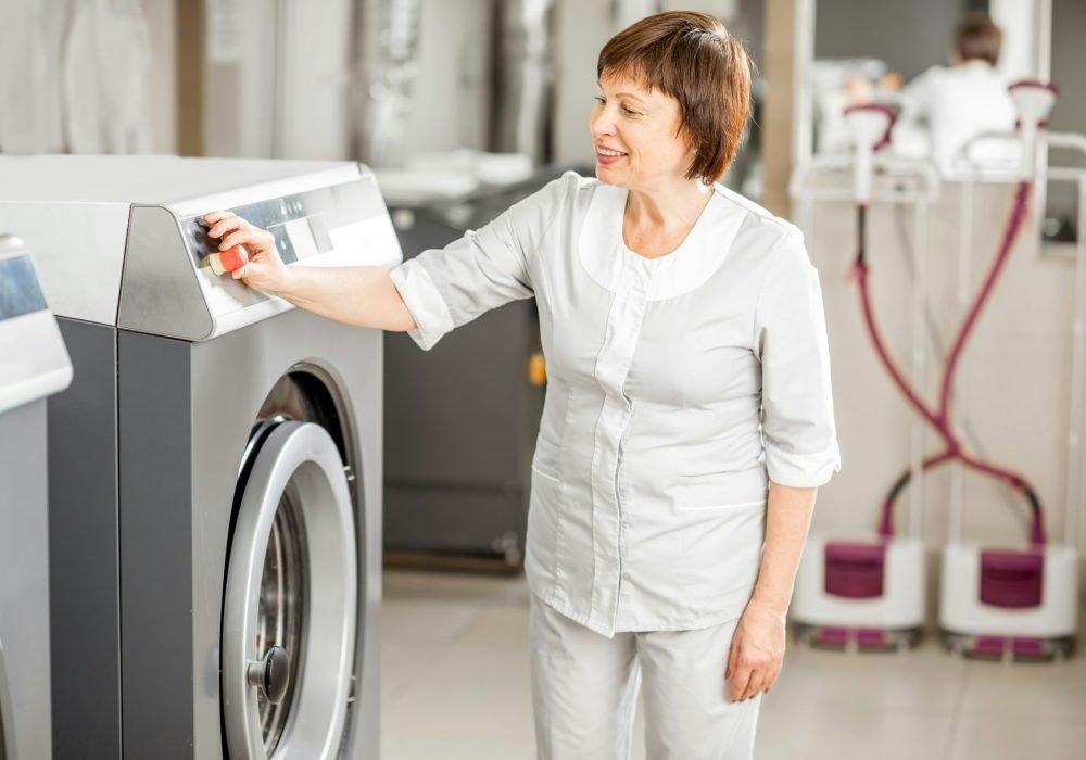 Senior washwoman in the laundry